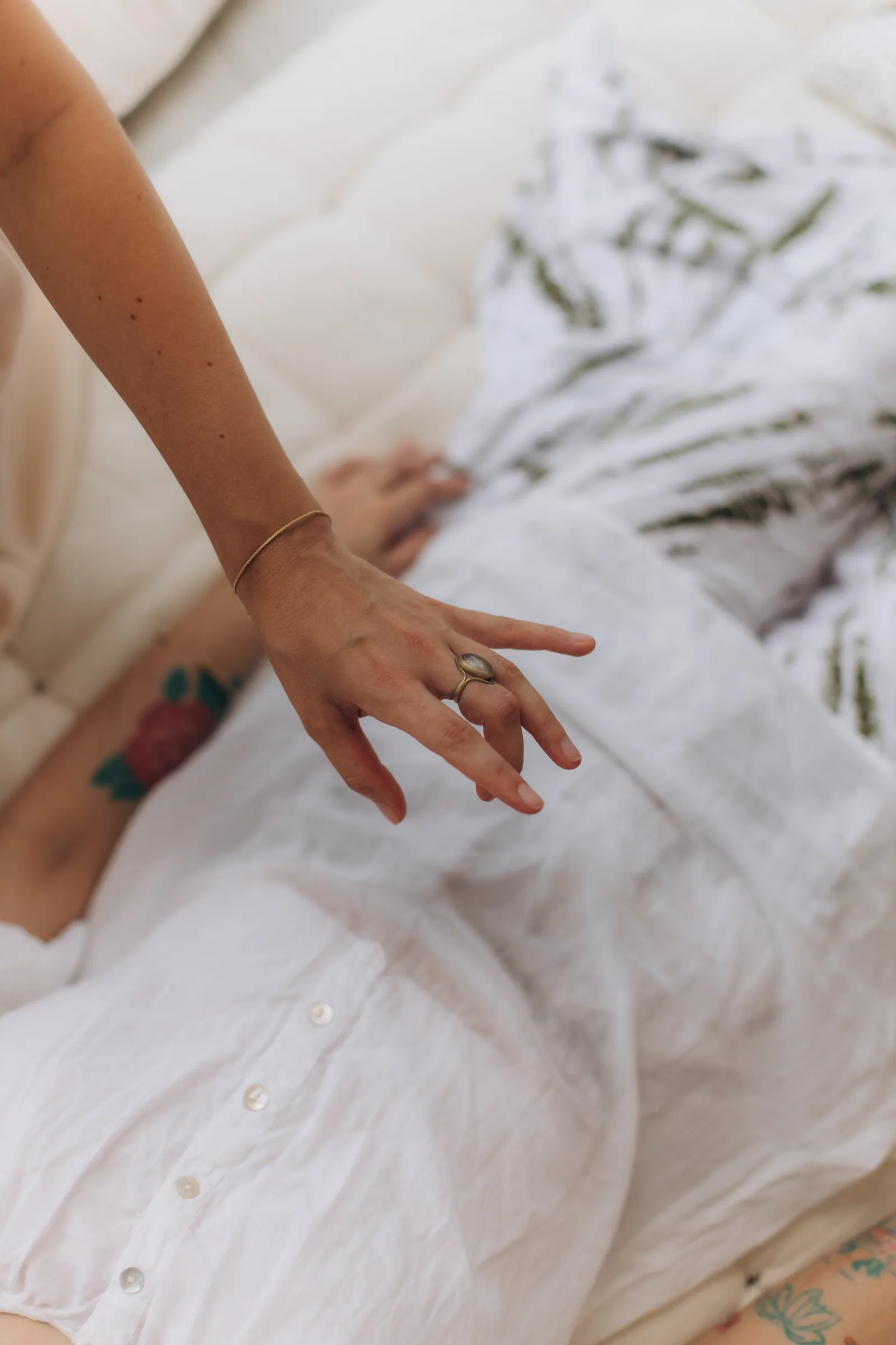 A hand resting open on white linen