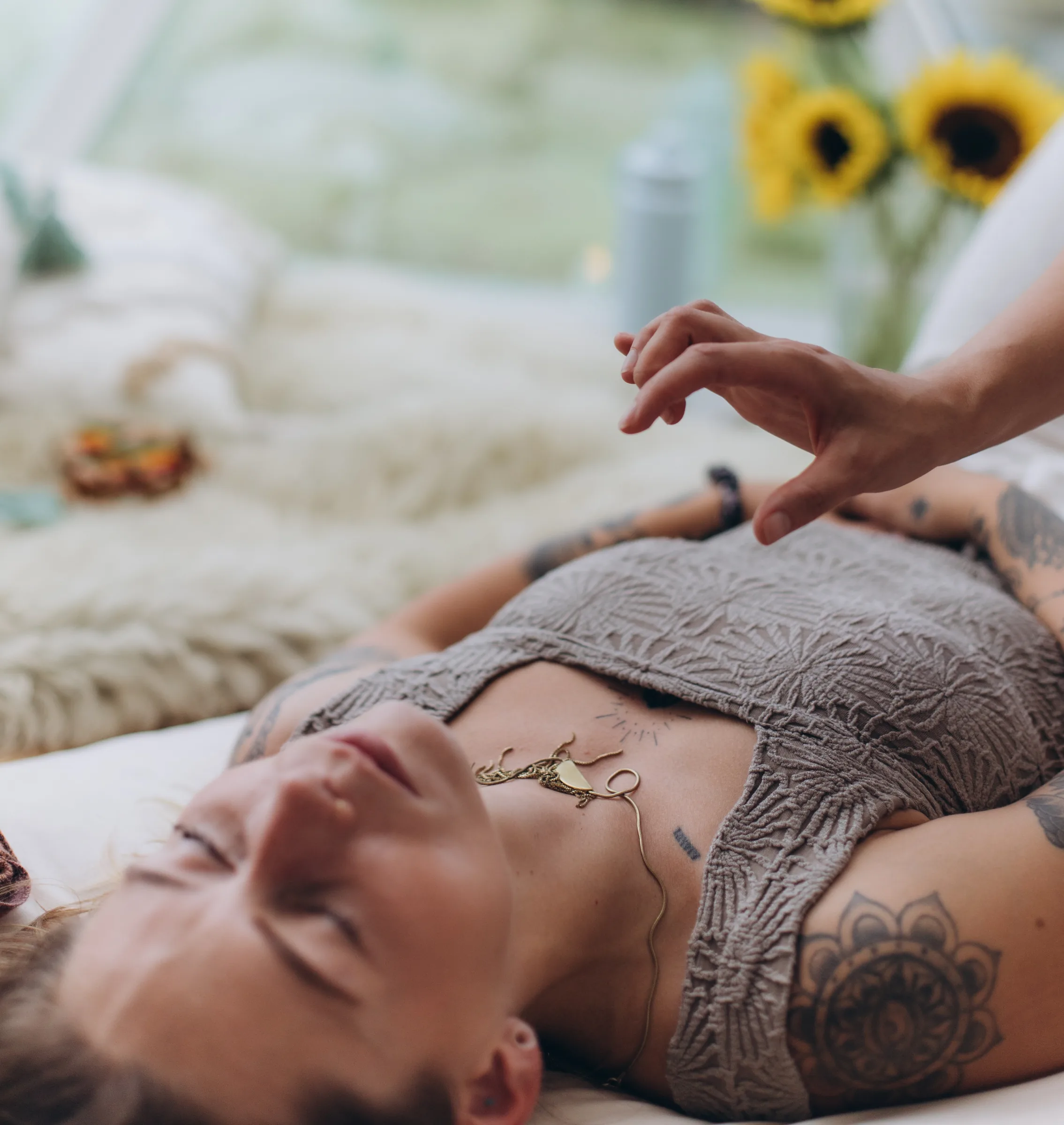Hands held just above a client's torso