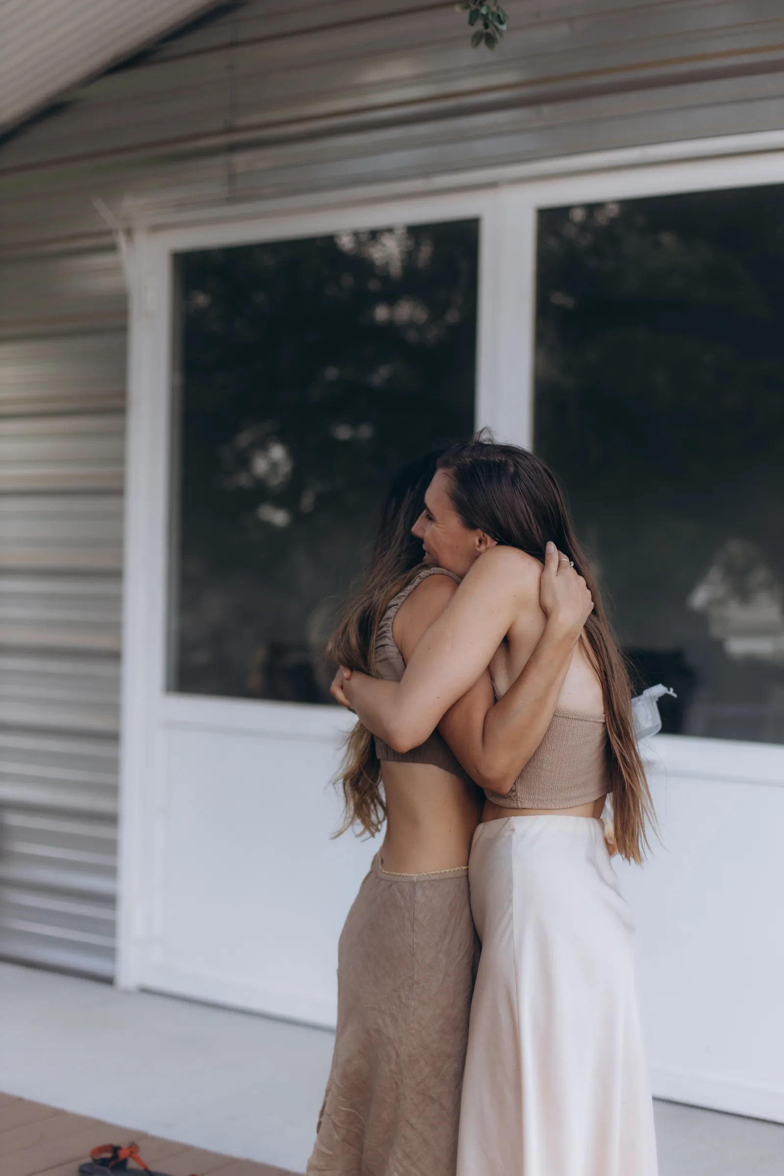 Two women holding each other outside the dome